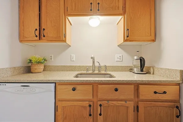 a bathroom with a granite countertop sink and a white cabinets