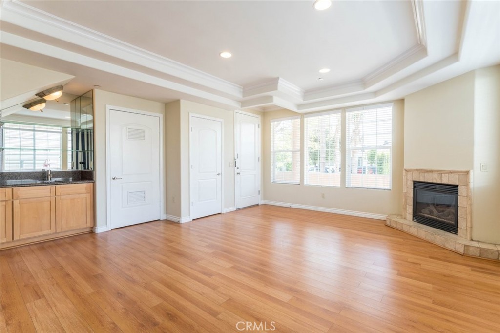 511 East Harvard Road, Unit 101 Burbank, CA 91501 - Photo 10 of 29 a view of an empty room with window and wooden floor