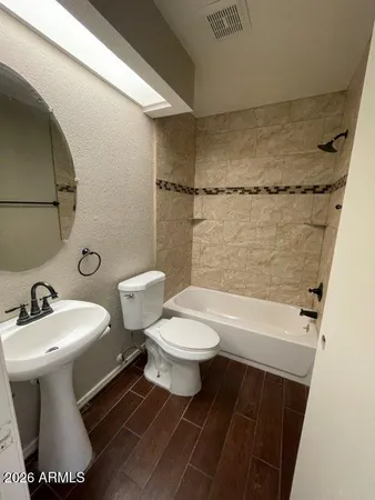 a bathroom with a toilet a sink and a shower