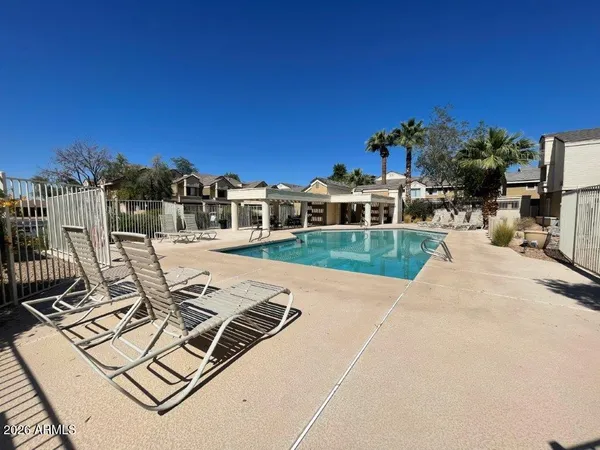 a view of a patio with a table and chairs