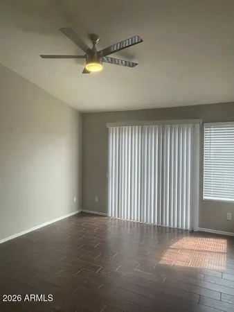 a view of a livingroom with a ceiling fan and window