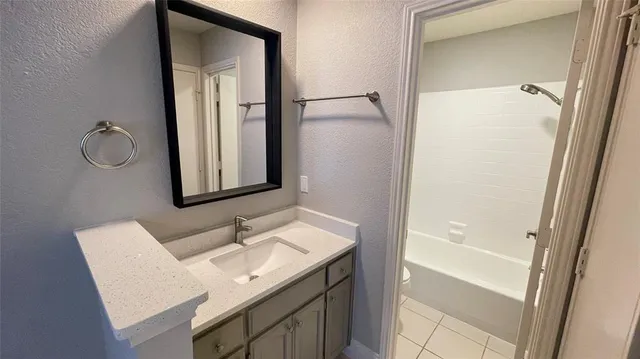 a bathroom with a sink a mirror and a shower