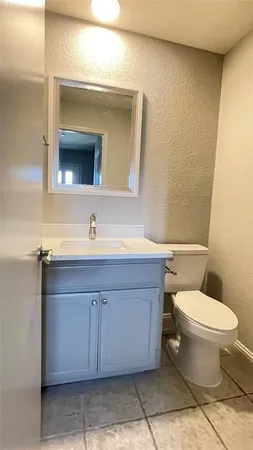 a bathroom with a sink toilet and mirror
