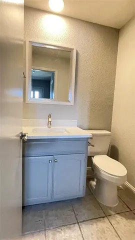 a bathroom with a sink toilet and mirror