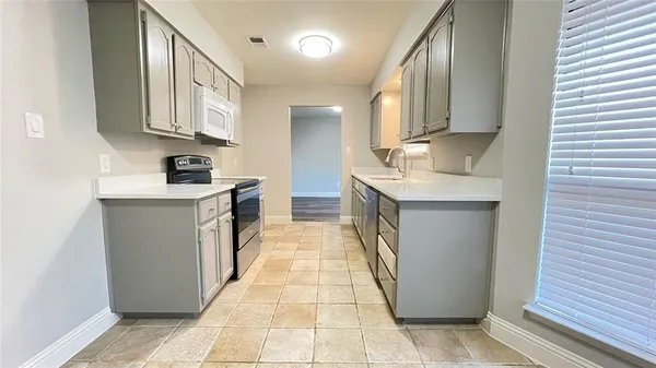 a kitchen with stainless steel appliances granite countertop a sink stove and cabinets