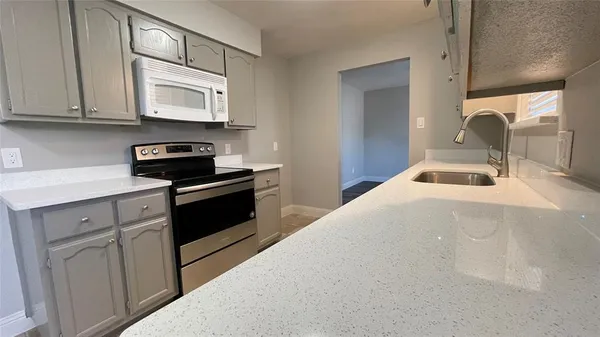 a kitchen with stainless steel appliances granite countertop a sink and cabinets