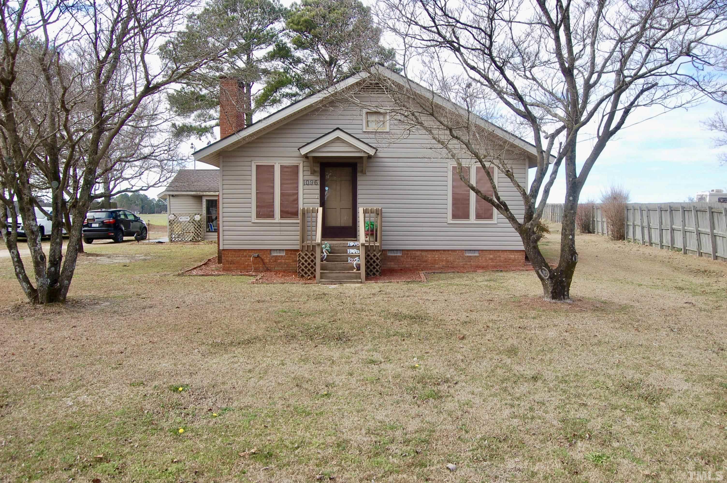 1096 Core Road Dunn, NC 28334 - Photo 1 of 15 a view of a house with a yard covered in snow