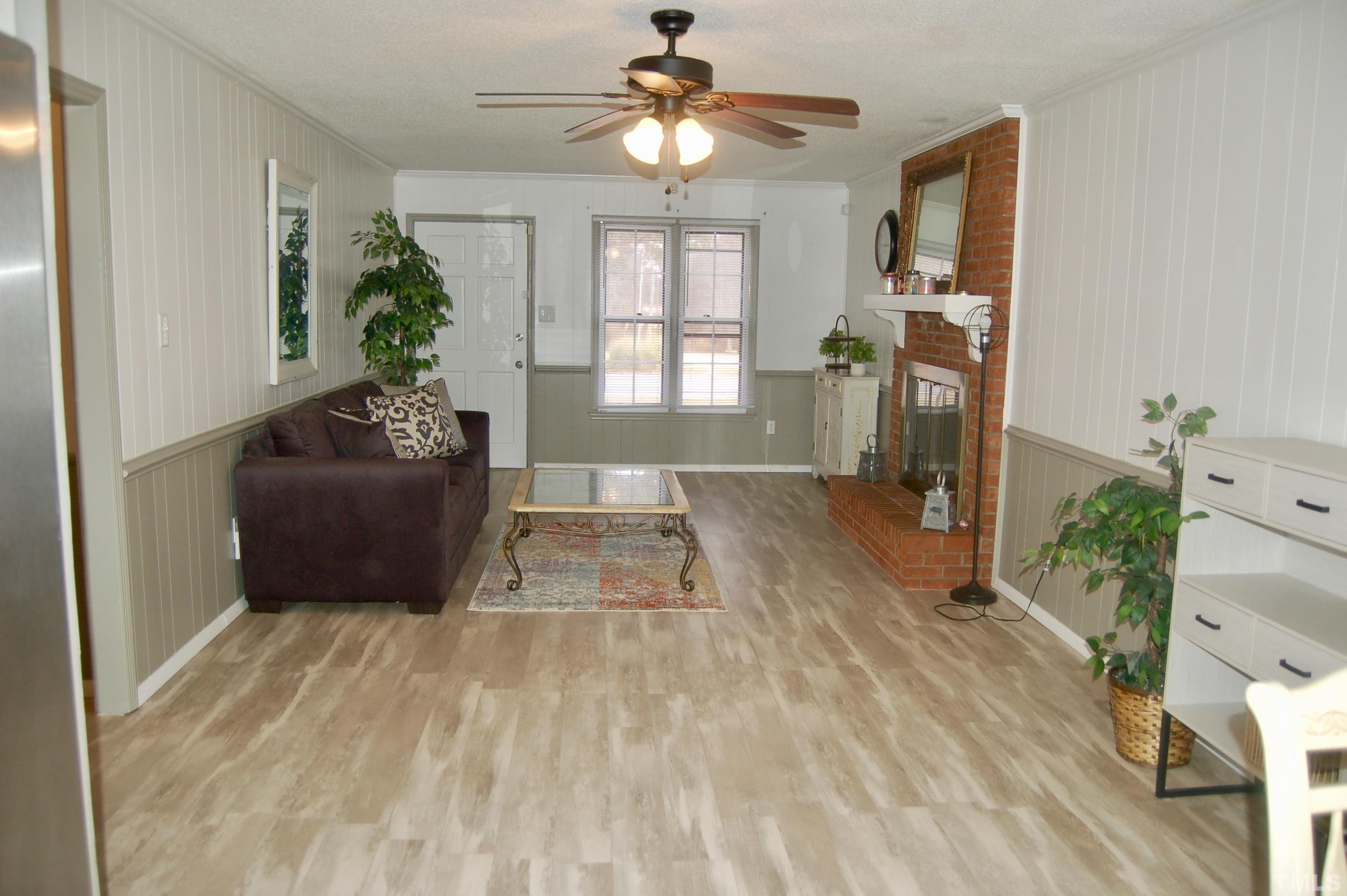 1096 Core Road Dunn, NC 28334 - Photo 5 of 15 a living room with furniture and a chandelier