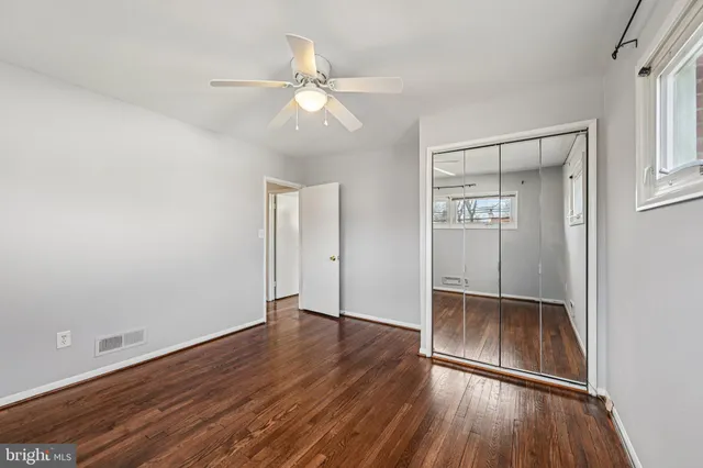 a view of room with wooden floor and ceiling fan