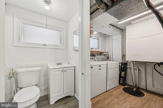 a front view of a house with a large tree