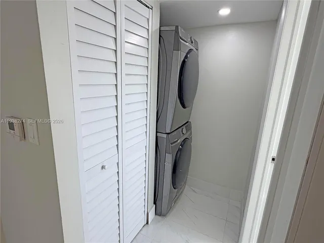 an empty room with wooden floor and a bathroom