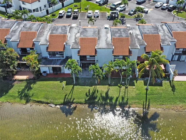 an aerial view of a houses with a swimming pool