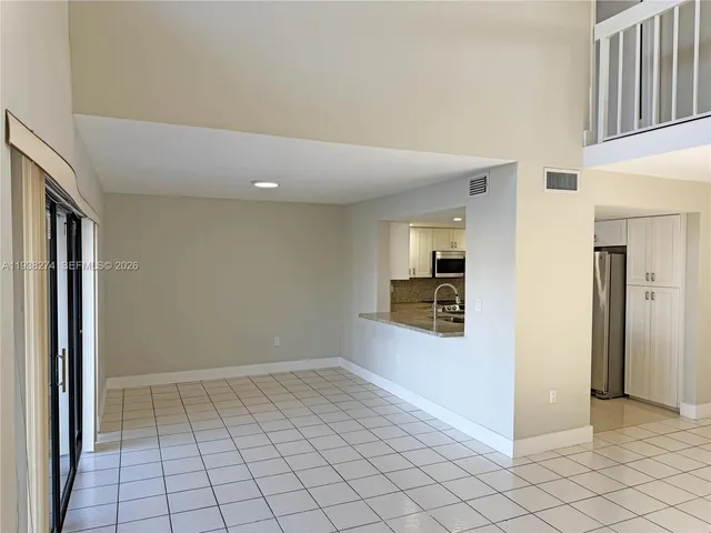 a kitchen with granite countertop a refrigerator sink and stove