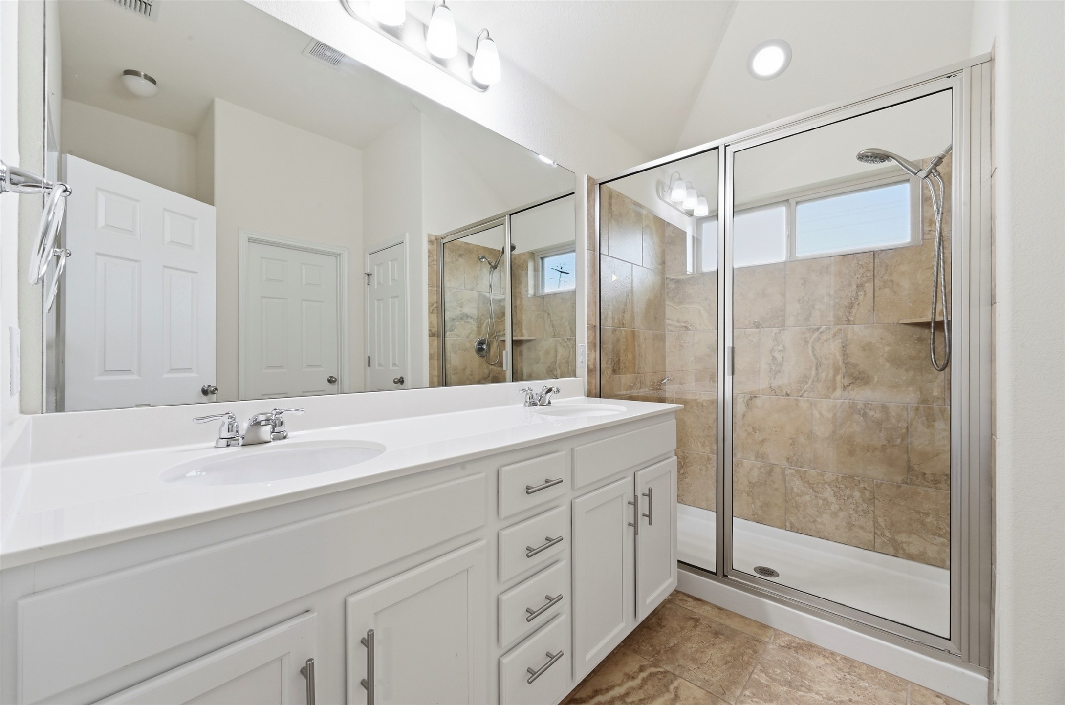 13116 Alans Way Manchaca, TX 78652 - Photo 14 of 25 Bathroom featuring a double vanity with white cabinetry, dual undermount sinks, and chrome faucets