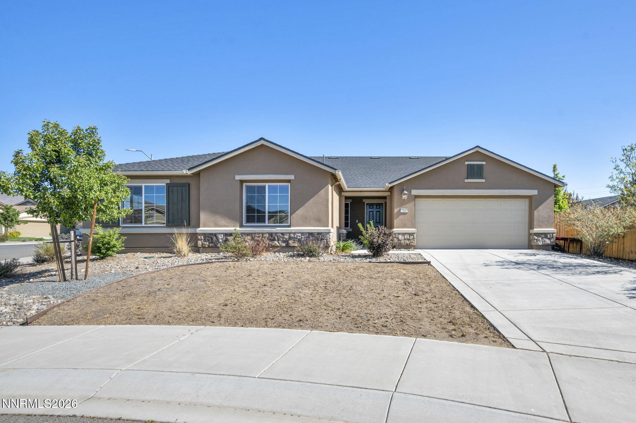 7181 Saddlehorn Road Carson City, NV 89701 - Photo 49 of 62 a front view of a house with a yard and garage