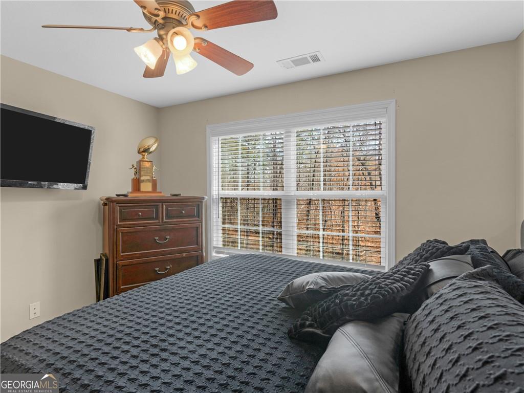 355 Parker Road Covington, GA 30014 - Photo 42 of 60 a bedroom with a bed and a television