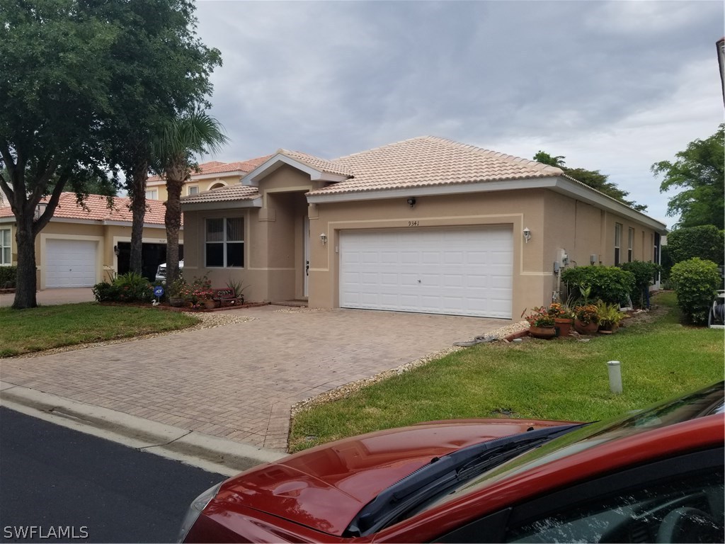 9341 Chestnut Tree Loop Fort Myers, FL 33967 - Photo 1 of 31 a front view of a house with a yard