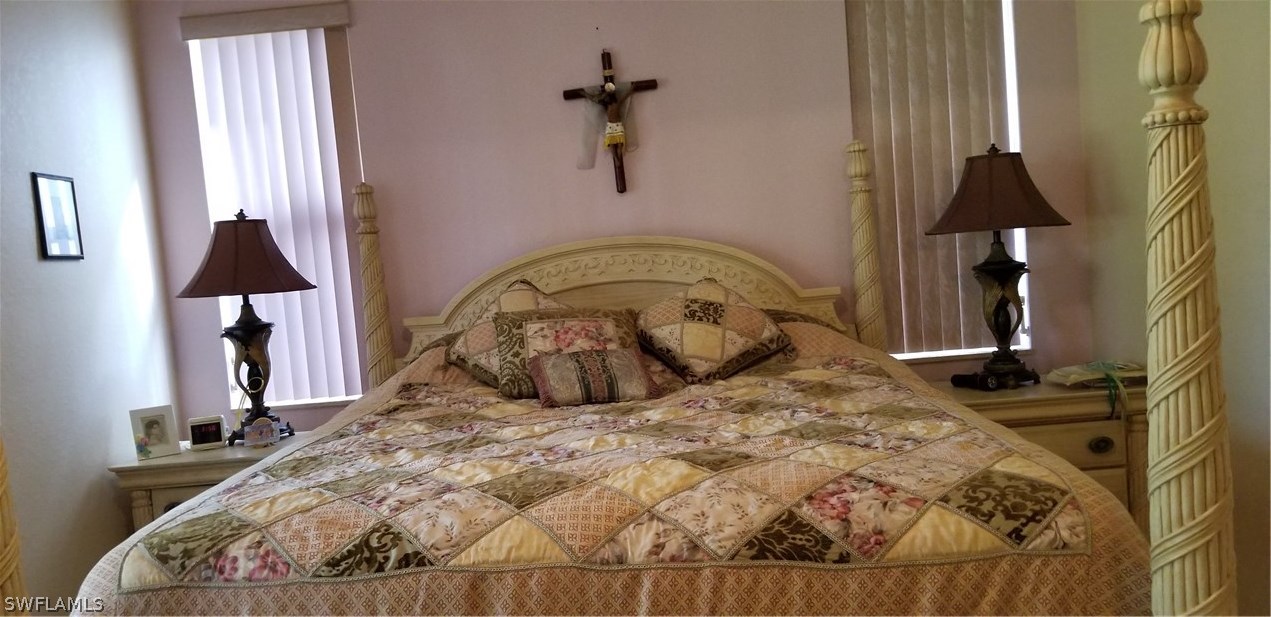 9341 Chestnut Tree Loop Fort Myers, FL 33967 - Photo 15 of 31 a bedroom with a bed and a window
