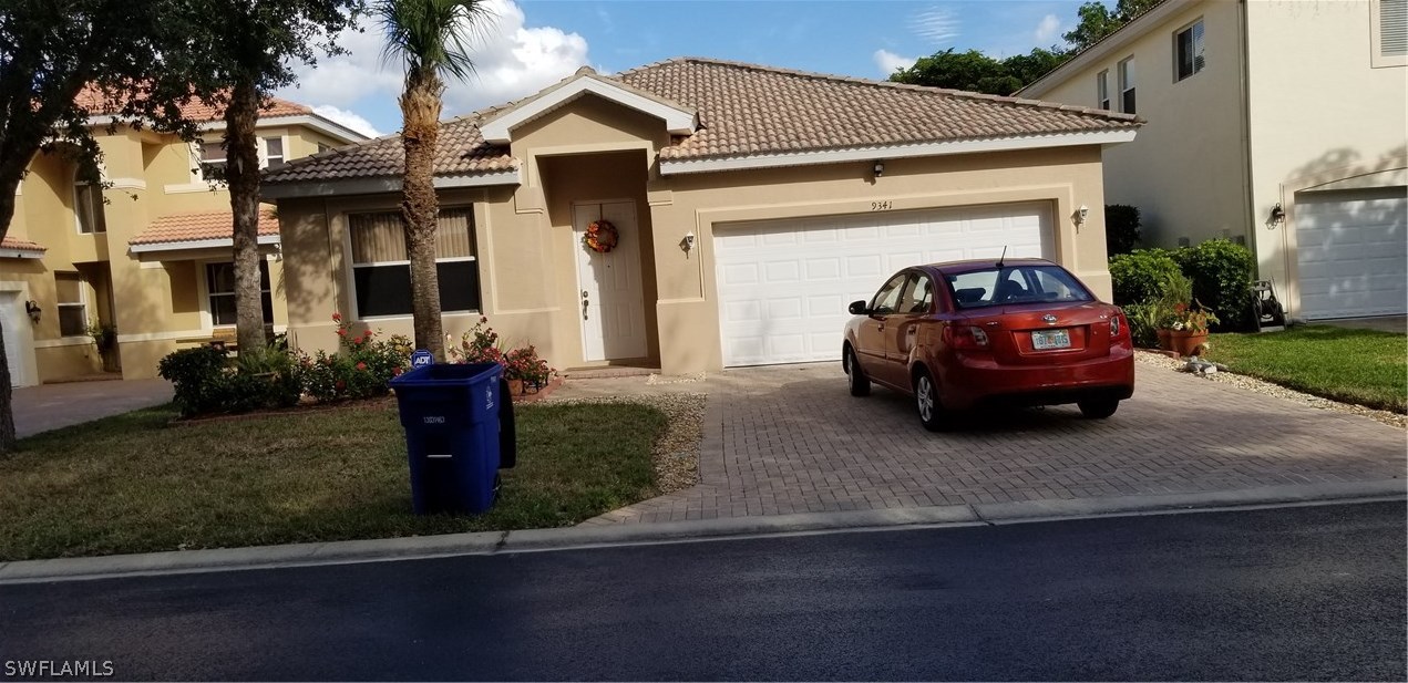 9341 Chestnut Tree Loop Fort Myers, FL 33967 - Photo 25 of 31 a car parked in front of a house