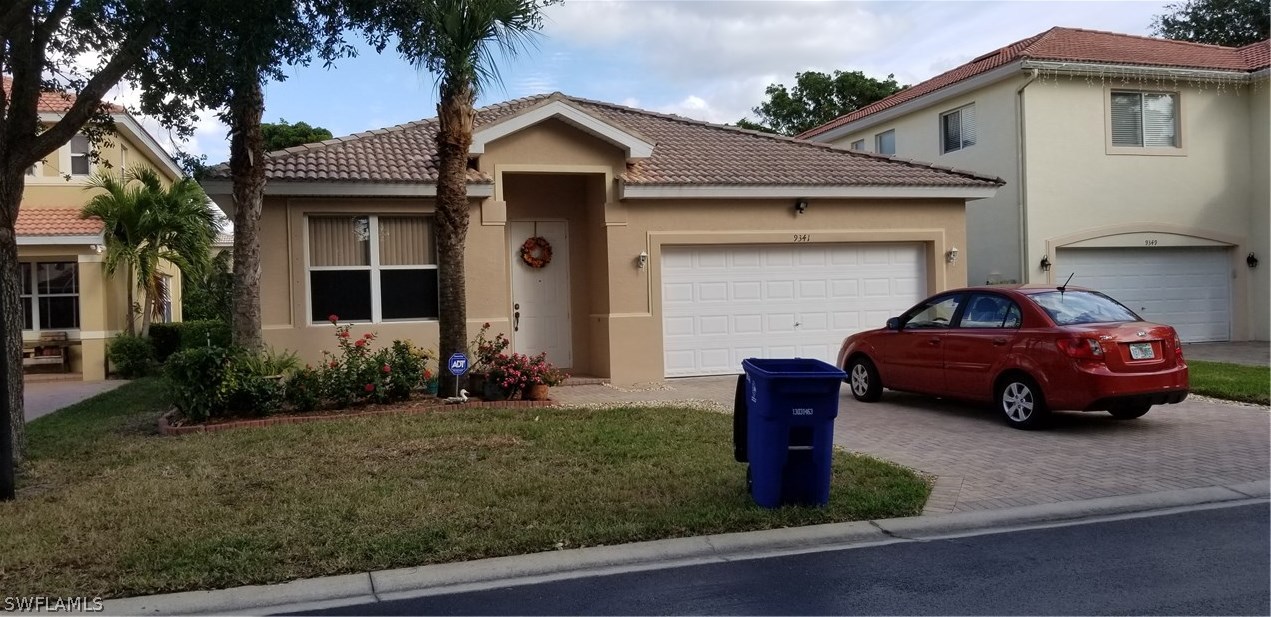 9341 Chestnut Tree Loop Fort Myers, FL 33967 - Photo 30 of 31 a car parked in front of a house