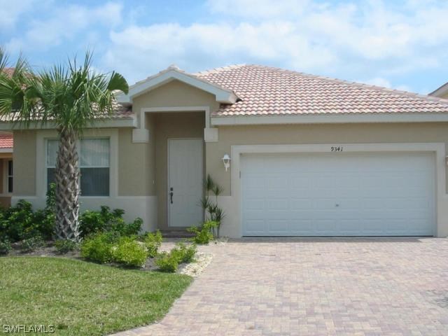 9341 Chestnut Tree Loop Fort Myers, FL 33967 - Photo 10 of 31 a front view of a house with garden