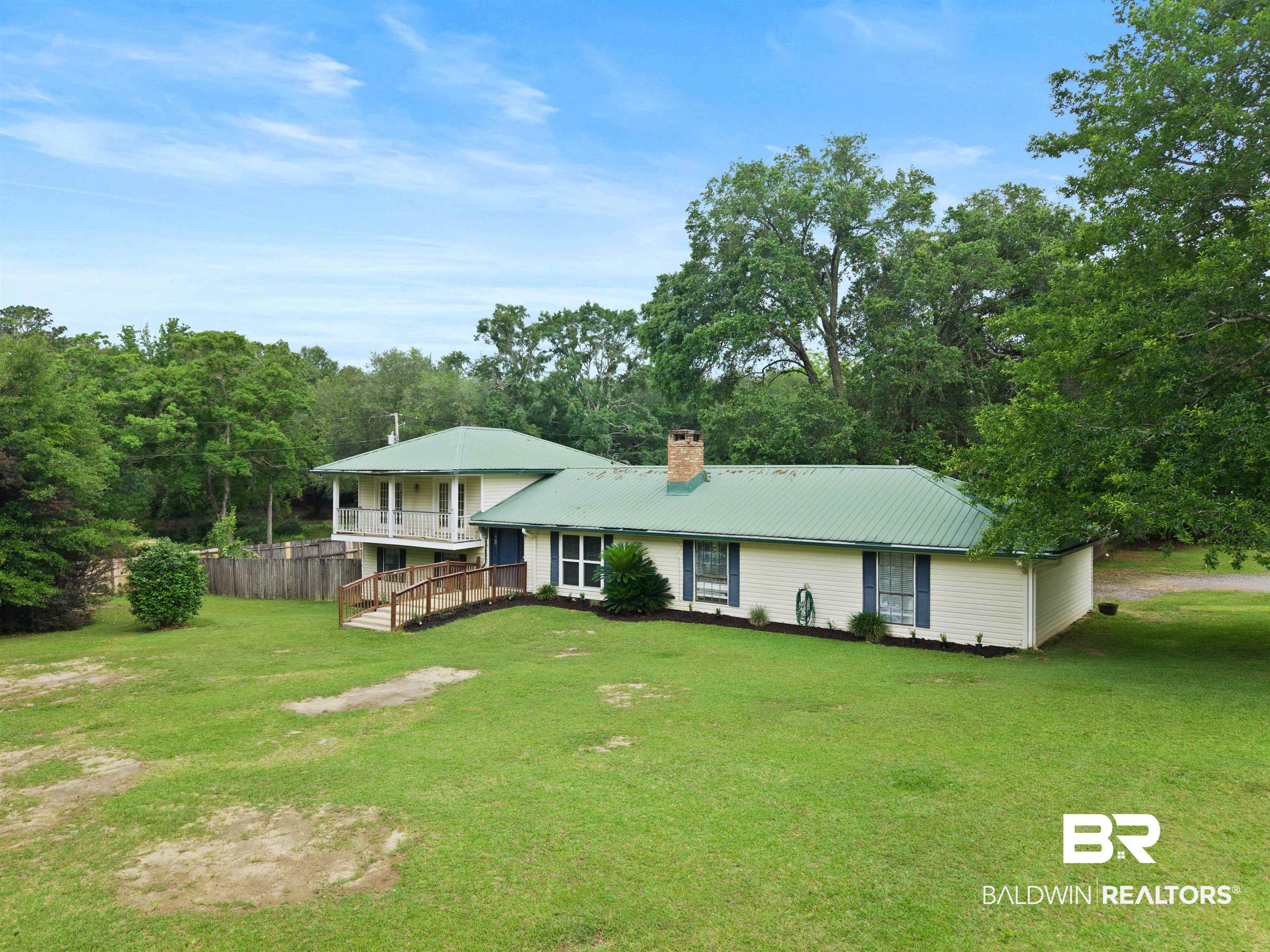 10420 Johnson Road South Mobile, AL 36695 - Photo 4 of 75 Single-story residence featuring a green metal roof and light-colored siding