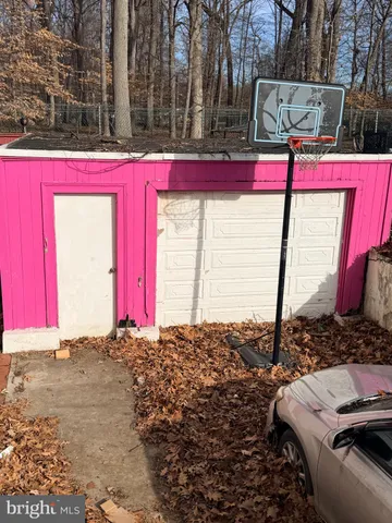 a house view with a sitting space and large trees