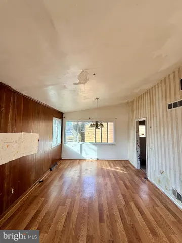 a view of a room with window and wooden floor