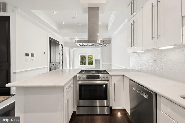 a kitchen with a stove and white cabinets