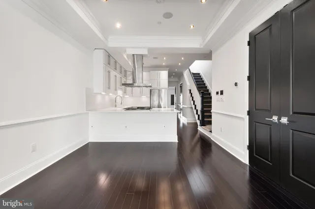 a view of entryway and hall with wooden floor
