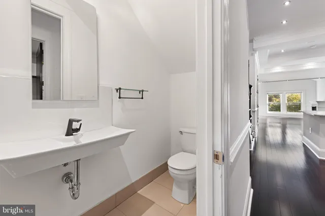 a white toilet sitting next to a bathroom sink