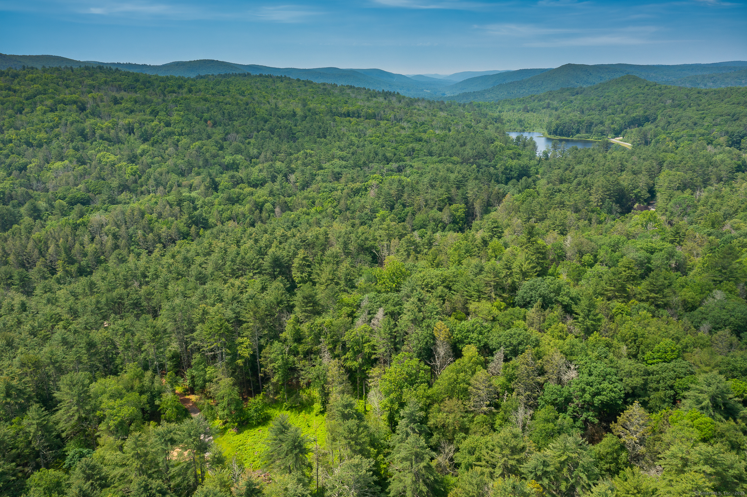 50 Popple Swamp Road Cornwall, CT 06754 - Photo 17 of 19 a view of a lush green hillside and a building