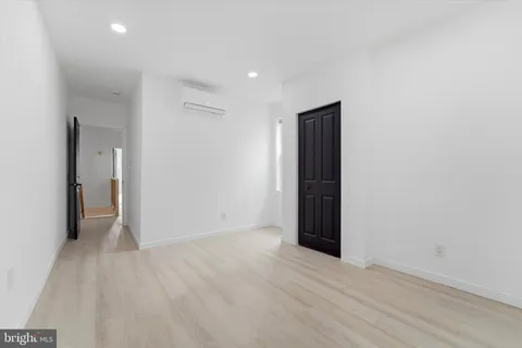 an empty room with wooden floor and closet