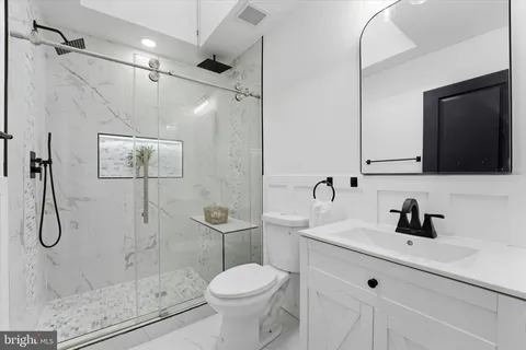 a bathroom with a sink toilet and shower