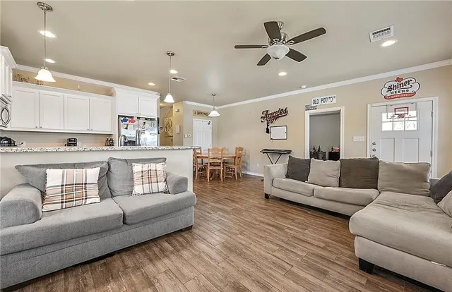 a living room with furniture and kitchen view