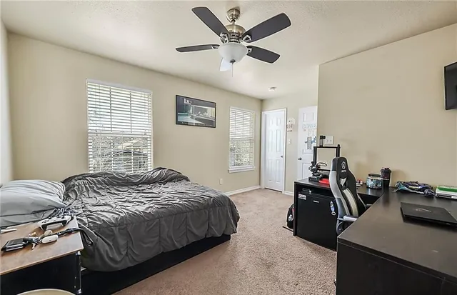 a bedroom with a bed and a large window