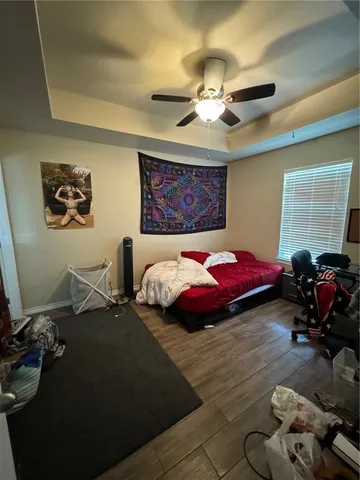 a bedroom with bed and a chandelier