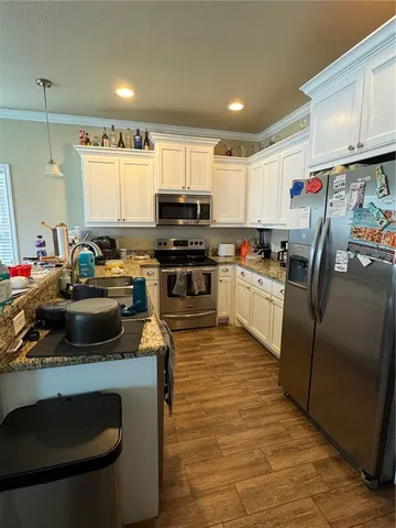 a kitchen with a sink stove and refrigerator