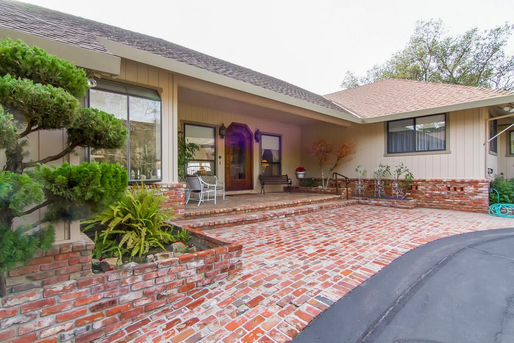 8900 Manfroy Ranch Road Gilroy, CA 95020 - Photo 2 of 12 a front view of a house with garden
