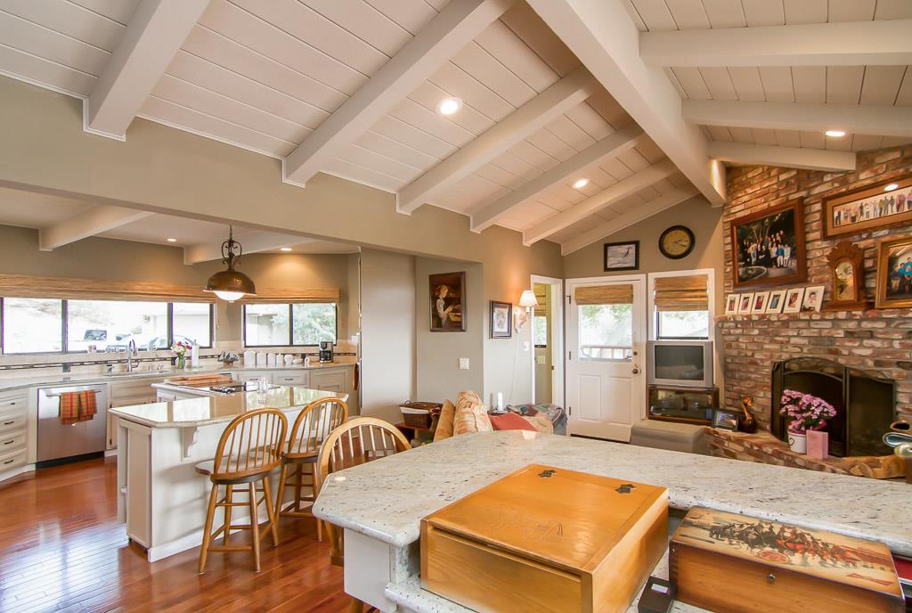 8900 Manfroy Ranch Road Gilroy, CA 95020 - Photo 6 of 12 a living room with stainless steel appliances kitchen island granite countertop furniture and a fireplace