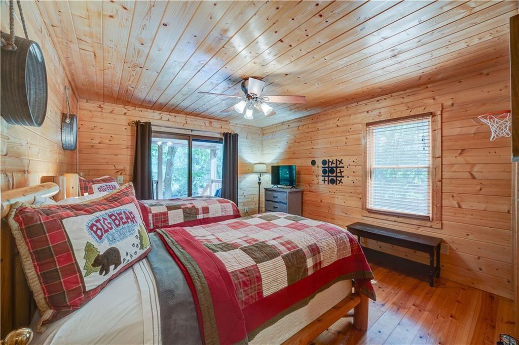 46 Floral Court Ellijay, GA 30540 - Photo 12 of 38 a bedroom with a bed next to a window with outer view
