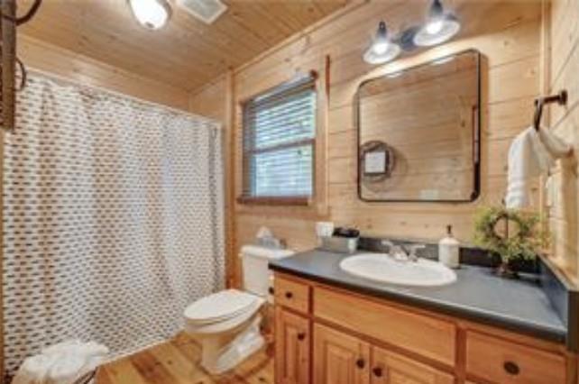 46 Floral Court Ellijay, GA 30540 - Photo 14 of 38 a bathroom with a granite countertop toilet sink and mirror