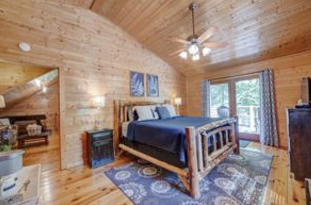 46 Floral Court Ellijay, GA 30540 - Photo 20 of 38 a bed room with a bed and a chandelier
