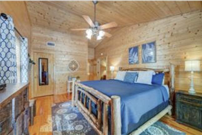 46 Floral Court Ellijay, GA 30540 - Photo 21 of 38 a bedroom with a bed and a chandelier
