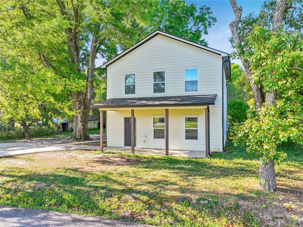 129 Pierce Hill Road Northeast Rome, GA 30161 - Photo 2 of 25 a view of a house with a yard and plants