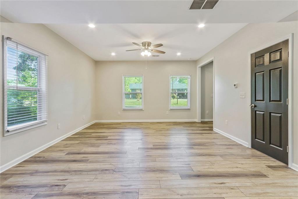 129 Pierce Hill Road Northeast Rome, GA 30161 - Photo 6 of 25 a view of an empty room with a window and wooden floor