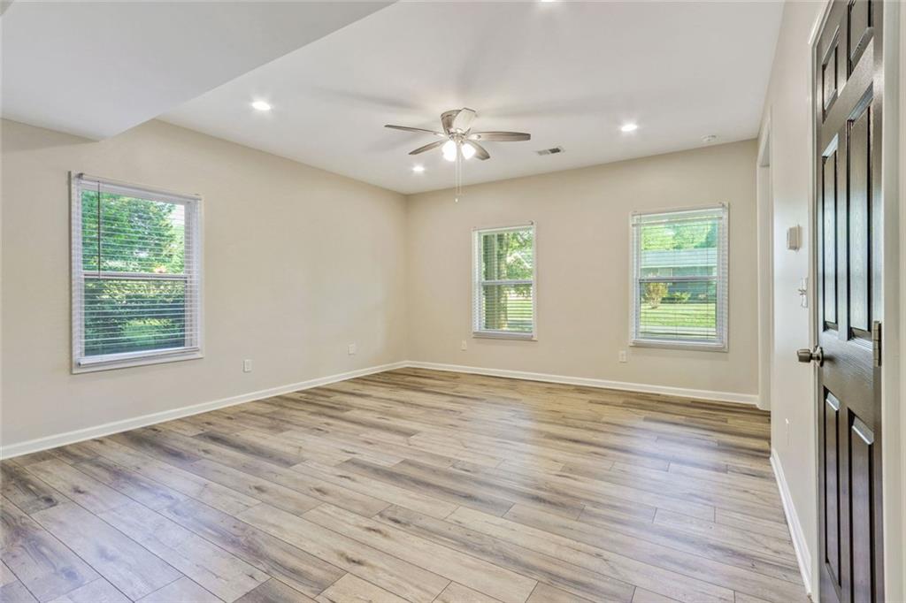 129 Pierce Hill Road Northeast Rome, GA 30161 - Photo 7 of 25 a view of an empty room with wooden floor and a window