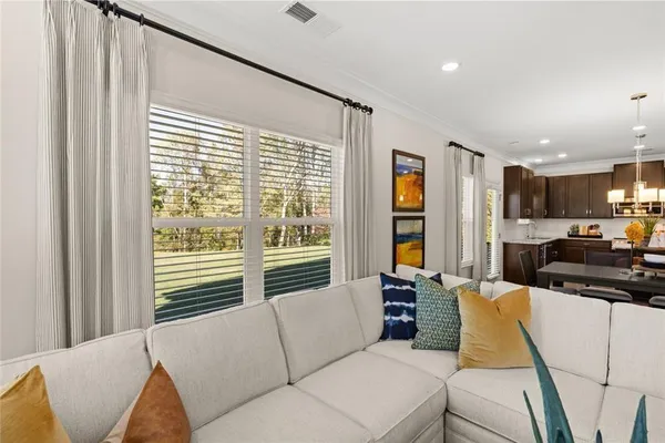 a living room with furniture and large windows