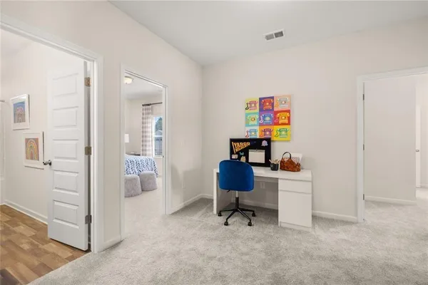 a bedroom with a bed and painting on the wall