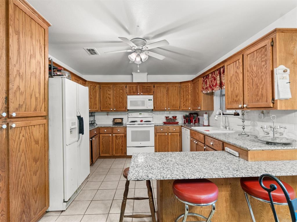 4608 Highway 154 Gilmer, TX 75644 - Photo 19 of 25 a large kitchen with a table and chairs
